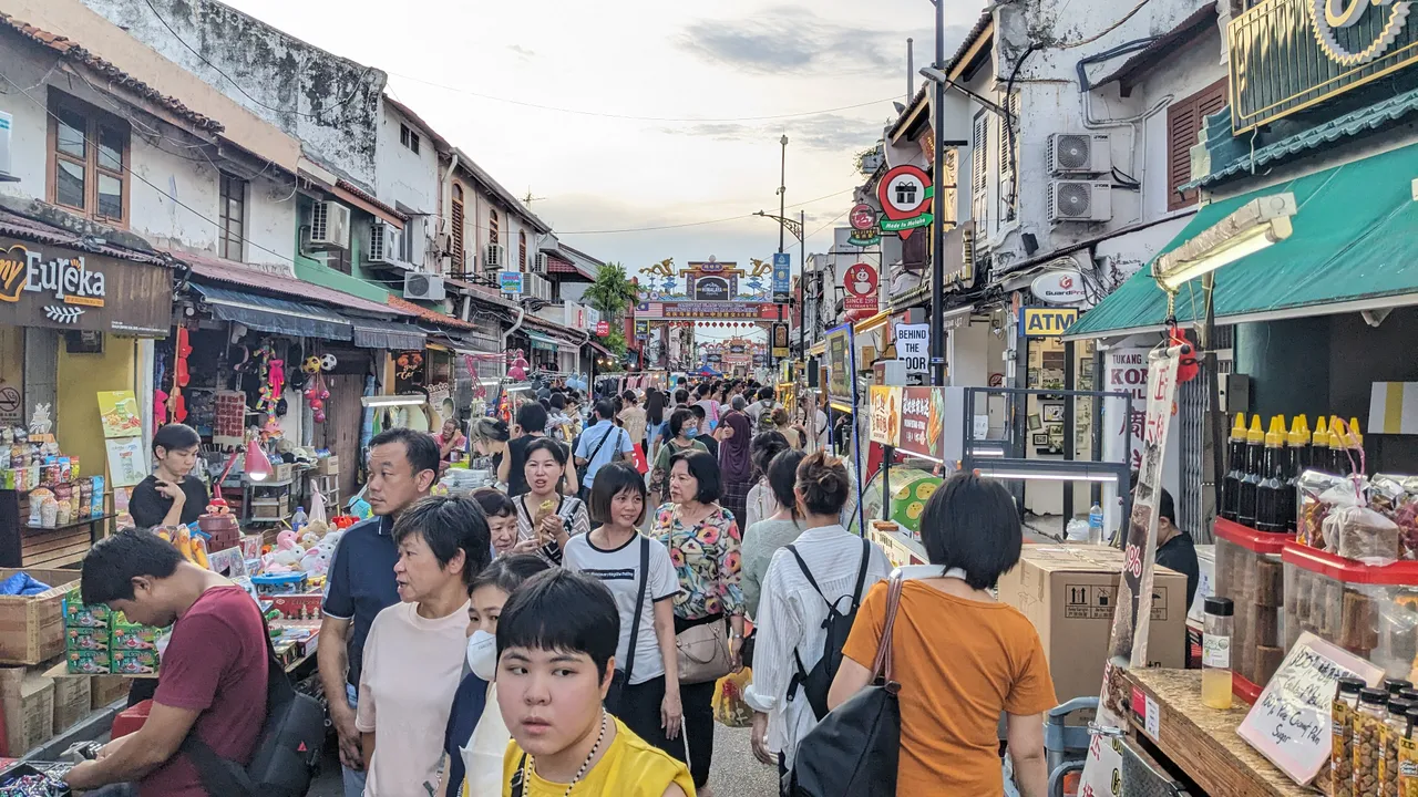 Crowds browsing stalls under shophouse eaves at Jonker Street Night Market in Melaka