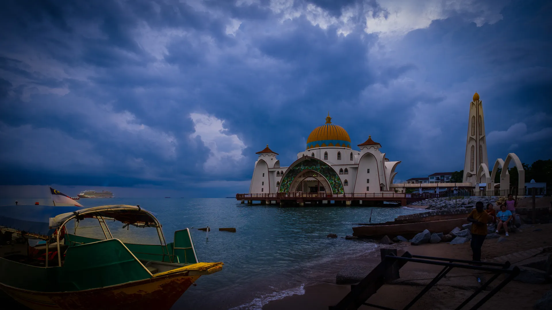 Masjid Selat Melaka illuminated beside the Strait of Malacca at dusk